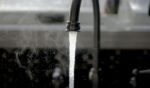 Tap water coming out of the faucet